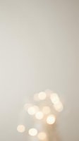 Soft warm bokeh lights on neutral beige background creating dreamy atmosphere for holiday celebrations and festive decorations.