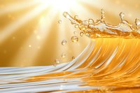 Golden liquid splash with droplets against sunbeam background, creating dynamic wave motion with transparent fluid and light reflections.
