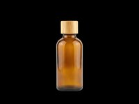 Amber glass bottle with bamboo cap, isolated on transparent background, ready for cosmetic, essential oil, and apothecary product label design use.