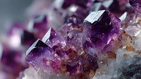 Vibrant purple amethyst crystal formation with faceted gemstones emerging from mineral base, showcasing natural geological structure in macro photography.