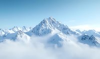 Majestic snow-covered mountain peak rising above misty clouds against clear blue sky, dramatic alpine landscape with rugged ridges and pristine winter scenery.