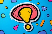 Yellow exclamation mark with pink background sticker on blue surface surrounded by colorful geometric shapes creating playful composition for modern design projects.