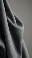 Soft gray fabric with natural draping and texture detail for interior design and textile applications.