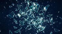 Shattered glass exploding on dark blue background, sharp fragments flying in dynamic burst with glowing light reflections and dramatic effect.