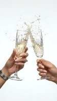 Two hands clinking crystal champagne flutes with a dramatic splash on a white background, capturing a festive celebration toast moment.