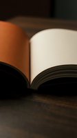 Open book with warm lighting on wooden surface creating cozy reading atmosphere for education and literature concepts.