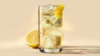 Refreshing sparkling lemonade drink with ice cubes and lemon slice garnish on beige background, perfect for summer beverage advertising.