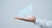 Business professional hand presenting holographic growth chart with upward trending bars showing financial success and data visualization for corporate presentations.