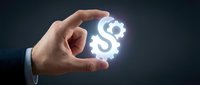 Hand holding glowing dollar sign symbol on dark background, representing financial success, money management, wealth creation, and business investment opportunities.