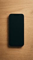 Smartphone with blank black screen on wooden surface, ready for app mockups, web design presentations, and digital marketing campaigns.