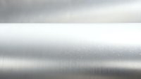 Brushed metal surface with horizontal lines and reflective finish for industrial design backgrounds and modern metallic textures.