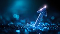 Glowing blue arrow pointing upward on dark background with bokeh lights and sparkle effects, representing growth, success and digital transformation.