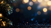 Magical holiday background with glowing bokeh lights and pine branches against dark blue backdrop, creating festive Christmas atmosphere.