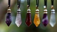 Colorful crystal pendants on black cords against blurred natural background. Healing stones including amethyst, rose quartz, amber, and clear quartz display mystical properties.