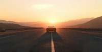 Car silhouette on empty highway during golden sunset with mountain range backdrop, dramatic long shadow cast on asphalt road, atmospheric orange sky.
