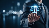 Professional businessman in dark suit touching glowing digital justice scales icon against blurred city lights background for legal technology concepts.