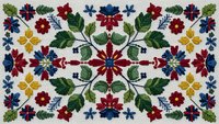 Traditional folk embroidery pattern with colorful flowers and leaves on white fabric. Decorative floral design for textile crafts and cultural heritage projects.