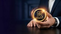 Professional businessman holding glowing document verification icon with checkmark symbol representing digital compliance and data security solutions.