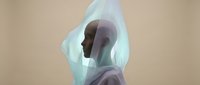 Young adult male with dark skin tone wrapped in translucent blue-tinted fabric, creating an ethereal, artistic portrait effect. Suitable for wellness, mental health, spirituality, and creative design projects.