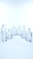 Collection of empty clear glass bottles and containers arranged on white background for product photography and design projects.