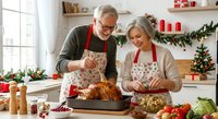 Senior Caucasian couple preparing festive holiday meal together in decorated kitchen, carving roasted turkey for Christmas dinner celebration.