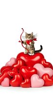 Tabby kitten with angel wings and cupid bow standing on pile of red and pink heart balloons, isolated on white background for Valentine's Day designs and romantic greeting cards.