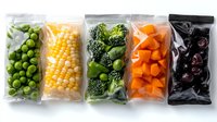 Frozen vegetables in transparent plastic bags arranged in row - peas, corn, broccoli, carrots and black cherries. Fresh healthy food storage concept.