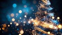 Magical spiral of golden and blue light trails with glowing bokeh effects on dark background creates festive holiday atmosphere. Perfect for seasonal designs.