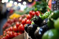 Fresh organic vegetables display at farmers market with colorful peppers, tomatoes and produce in grocery store setting with warm bokeh lighting effects.