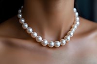 Elegant white pearl necklace on mannequin neck closeup, lustrous round beads with soft focus background for luxury jewelry and fashion accessories.