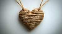 Heart shape made from natural jute rope on light background, rustic handmade decor element with twine texture and romantic symbolism for craft projects.