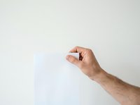 Male hand holding small black object against white background, suitable for product mockups, tech presentations, and commercial advertising.