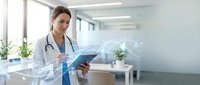 Female doctor using digital tablet with holographic medical data display in modern hospital office for healthcare technology and patient care.