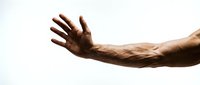 Man with dark skin tone extending open hand in welcoming gesture against white background, suitable for concepts of help, support, assistance, and human connection.