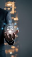 Businessman holding glowing justice scales with people icons representing legal services, law firm consultation, and professional legal advice concepts.