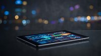 Modern tablet displaying colorful financial trading charts and data analytics on dark surface with blurred city lights bokeh background for business technology.