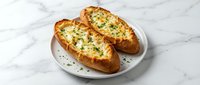 Twice-baked potatoes stuffed with creamy cheese and fresh herbs served on white plate, comfort food for restaurant menus and cooking blogs.