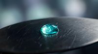 Turquoise gemstone on dark textured surface with soft bokeh background for jewelry design and luxury product photography applications.