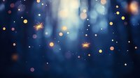 Magical glowing sparkles and bokeh lights floating in dark blue mystical forest atmosphere, creating dreamy ethereal effect for festive backgrounds.