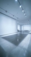 Modern minimalist gallery interior with white walls, polished concrete floors and track lighting system for contemporary art exhibitions.