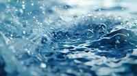 Macro shot of water surface with splashing droplets and dynamic waves creating abstract pattern in blue tones. Natural water motion background.