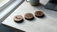 Wooden circular stamps with engraved mail, message, and target symbols arranged on white surface near window, office workspace setup for communication and business branding projects.