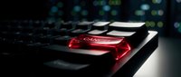 Glowing red cancel button on a dark mechanical keyboard, dramatic lighting, technology concept for cybersecurity, error, or abort action themes.