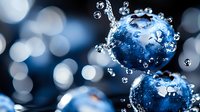 Fresh blueberries splashing in crystal clear water with dynamic droplets and bubbles against soft bokeh background for healthy lifestyle concepts.