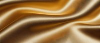 Luxurious golden brown silk fabric with soft waves and folds creating elegant light and shadow effects. Smooth satin texture background for fashion and luxury designs.
