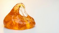 Amber-colored translucent resin or glass blob with organic flowing shape, isolated on white background, suitable for design projects, overlays, and digital art compositions.