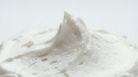 Whipped cream or mousse with peaks and swirls on white background, isolated for culinary, baking, food packaging, and dessert design projects.