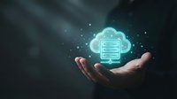 Businessman hand holding glowing cloud computing server icon with data storage technology concept for digital transformation and IT solutions.