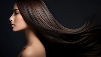 Young Asian woman with flowing long straight dark brown hair against black background, profile view showing smooth skin and natural makeup for beauty and haircare.