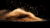 Glittering gold dust cloud with sparkling particles floating against dark background creates magical atmospheric effect for luxury design projects.